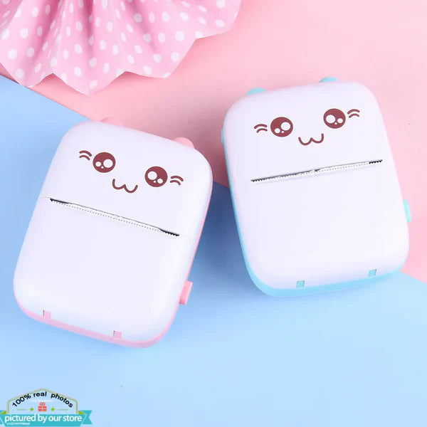 Image of two mini thermal pocket printers, one in pink and one in blue, showcasing their compact size and vibrant colors.