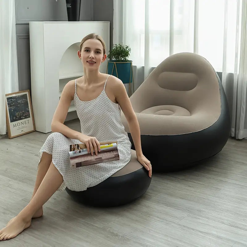 Girl posing while sitting on the footrest of the inflatable lounge chair. The image highlights both the chair and footrest, demonstrating their comfort and style.